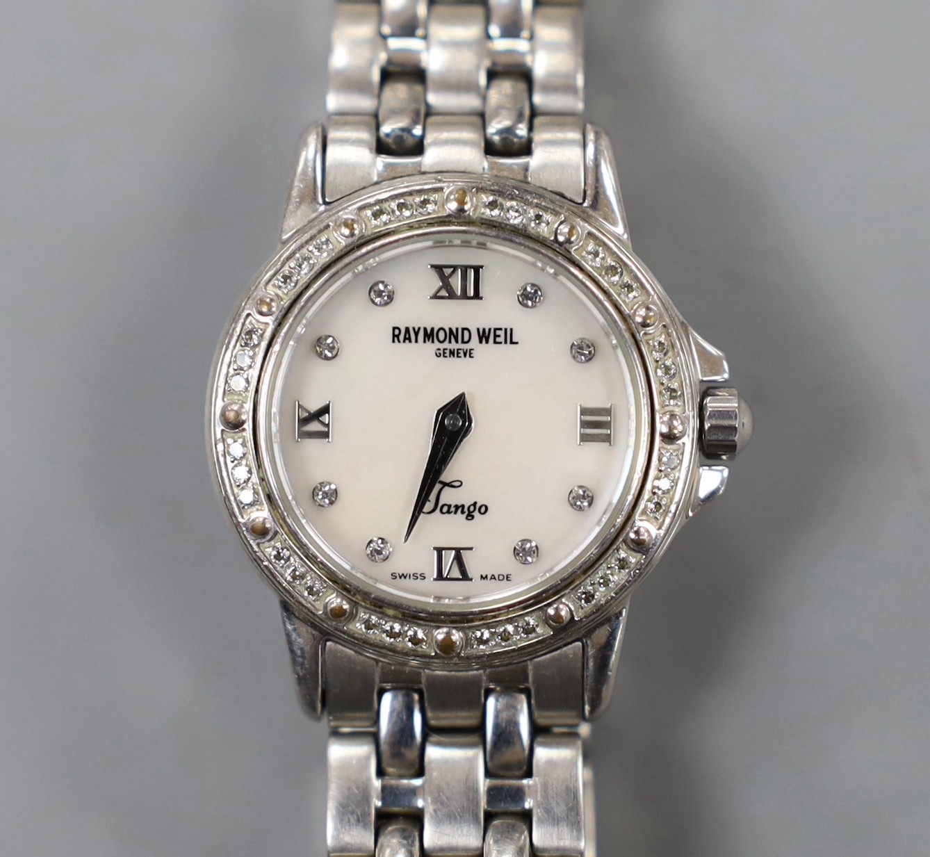 A lady's modern stainless steel Raymond Weil quartz wrist watch and bracelet, with diamond chip set bezel and mother of pearl dial with diamond set markers, with box.